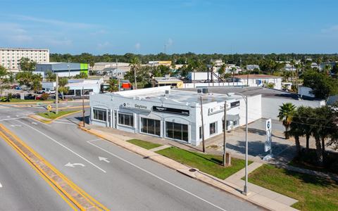Angled aerial of the corner lot at Fairview Avenue and Beach Street, showroom windows along both frontages