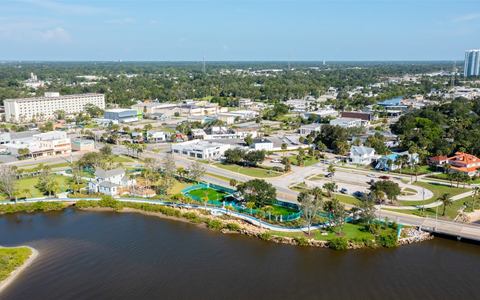 Aerial looking west over the building to the riverfront park, the playground and the hotel beyond